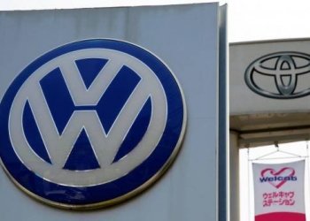 The logos of Volkswagen and Toyota Motor Corp are seen at their dealership in Tokyo Japan