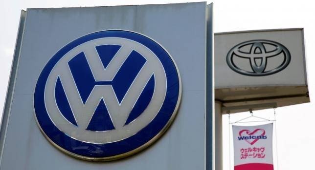 The logos of Volkswagen and Toyota Motor Corp are seen at their dealership in Tokyo, Japan