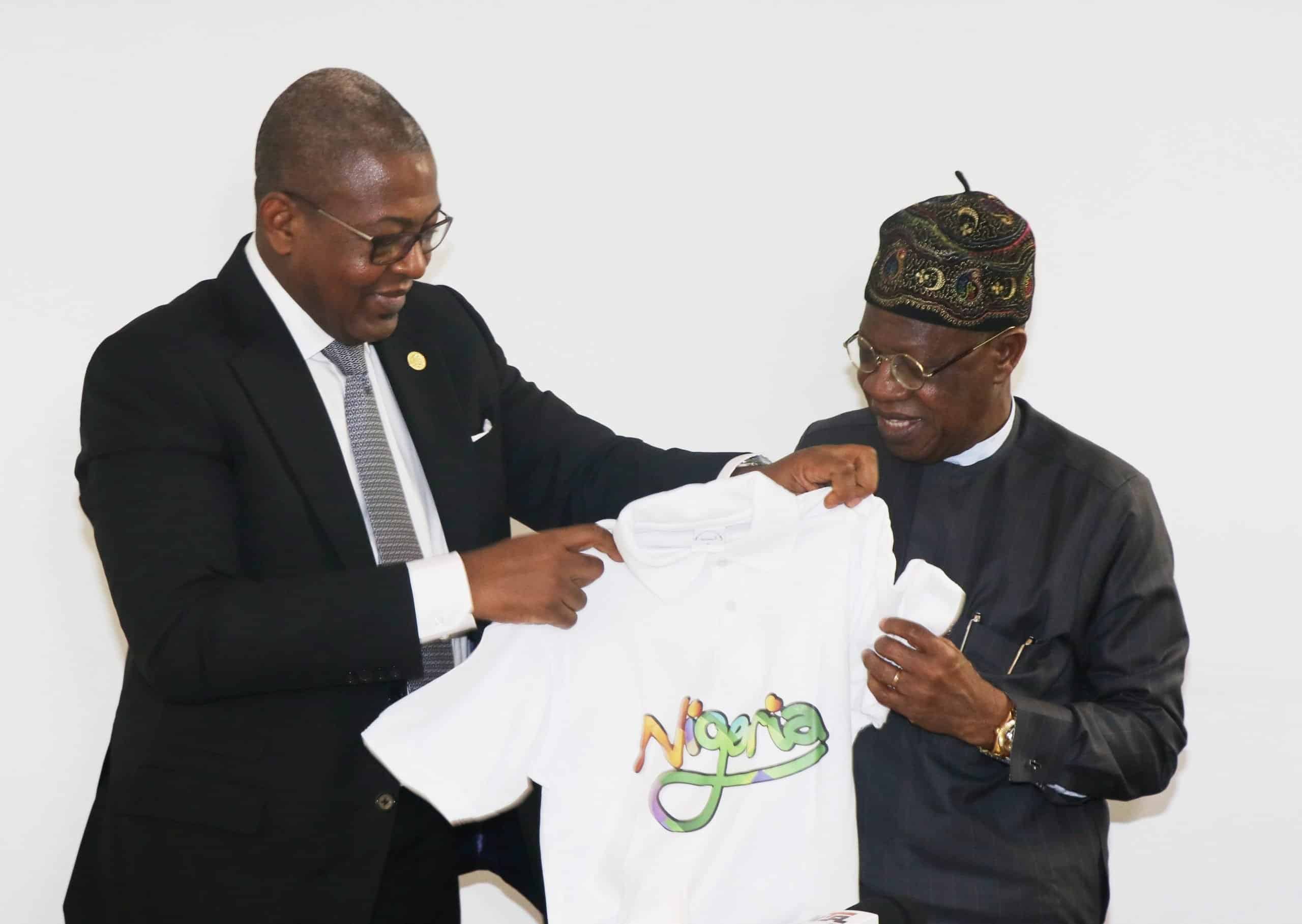 Folorunsho Coker presenting a Tour Nigeria T-Shirt to Alh. Lai Mohammed